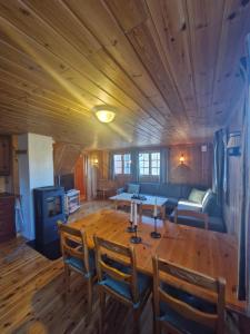 un soggiorno con un tavolo di legno e un divano di Fjellvang a Haglebu
