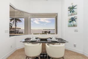 a dining room with a table and chairs and a window at Coastal River Oasis in Cape Coral