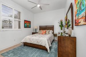 a bedroom with a bed and a ceiling fan at Coastal River Oasis in Cape Coral +44 photos