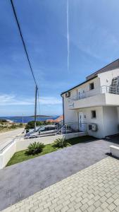 a white building with the ocean in the background at VisitAylinVis in Vis