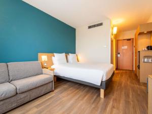 Ένα ή περισσότερα κρεβάτια σε δωμάτιο στο Novotel Roma Est