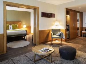 a hotel room with a bed and a table at Hotel Mercure Porto Gaia in Vila Nova de Gaia +113 photos