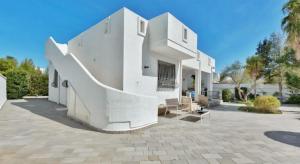 een wit huis met trappen en palmbomen bij Elements Rooms in Porto Cesareo
