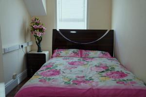 a bedroom with a bed and a vase of flowers at SS Sunrise & Silk in Bersted +9 photos