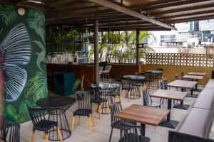 a restaurant with tables and chairs on a patio at Olivar House Hotel in Lima