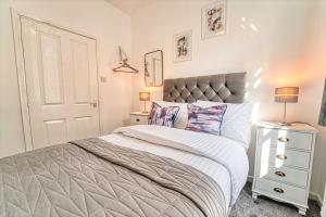 a bedroom with a large bed and a white dresser at New Street - City Centre! in Worcester