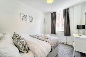 a bedroom with a bed and a desk and a window at New Street - City Centre! in Worcester