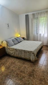 a bedroom with a large bed and a window at Davolio Hosting in Yerba Buena +4 photos