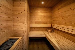 a wooden sauna with a hot tub in it at Le Refuge de Lucien - OVO Network in Gérardmer