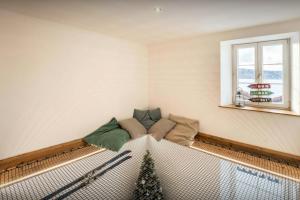 a dog bed in a room with a christmas tree at Le Refuge de Lucien - OVO Network in Gérardmer