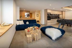 a living room with a blue couch and a pool table at Le Refuge de Lucien - OVO Network in Gérardmer +13 photos