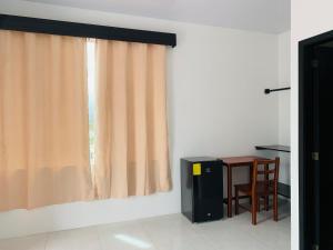 a room with a table and a window with a chair at Habitaciones privadas in Puerto Villamil