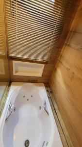 a bath tub in a room with a window at Casa do Sossego in Florianópolis +36 photos