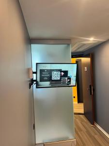 a refrigerator with a microwave on top of it at The Hyve Budget Hotel Rotterdam in Rotterdam