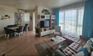 a living room with a couch and a table at GIGI Apartment in Belgrade