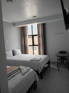 Ένα ή περισσότερα κρεβάτια σε δωμάτιο στο Hostal Huella