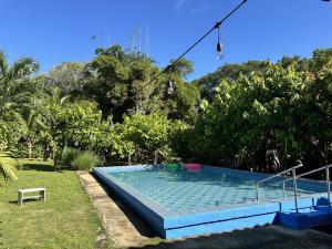a swimming pool in the yard of a house at Cabañas Green Hills in Las Minas