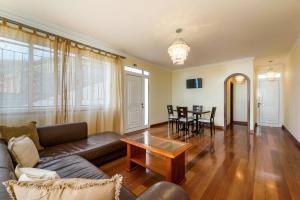 a living room with a couch and a table at Casa da Georgina by GALMI in Arco da Calheta