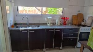 a kitchen with a sink and a counter top at Okin 22 La Reserva in Costa del Este