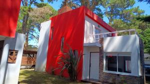 a house with a red and white facade at Okin 22 La Reserva in Costa del Este