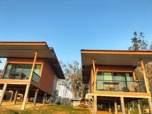 two story houses with balconies and tables on them at Baan Seaview Sunset in Ko Lanta