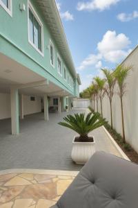 a building with a courtyard with a plant in a pot at Pousada Residencial A Dantas in Búzios