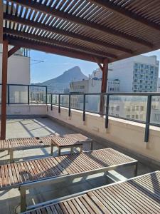 a balcony with benches on top of a building at Cape Town CBD Pool Near CTICC Parliament Waterfront in Cape Town +41 photos