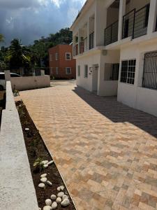a brick driveway in front of a building at Angella Mansions in Stony Hill