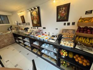 a bakery with a counter filled with lots of food at Awki´s Dream Hotel in Cusco
