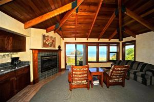 a living room with a couch and a fireplace at Elk Cove Inn & Spa in Elk
