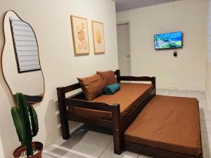 a bed in a room with a cactus at Casa aconchegante pertinho da Praia Central in Itapema