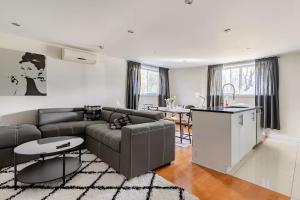 a living room with a couch and a table at Voltaire 1 Apartement 4,5 2ch Laval, Canada in Laval