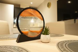 a mirror sitting on top of a table at Modern & Cozy Flat in the Heart of Chelmsford - F7 in Chelmsford +3 photos