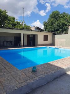 a large blue swimming pool next to a building at Residencial Paraviana-Casa Piscina in Boa Vista