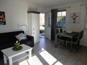 a living room with a couch and a table at Refugium 54° Timmendorfer Strand in Timmendorfer Strand