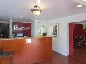 a lobby of a restaurant with a reception desk at Caravelle Inn Extended Stay in San Jose