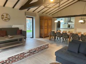 a living room with a table and a dining room at Five-Bedroom Holiday Home in Somme-Leuze in Somme-Leuze