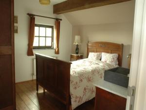 a bedroom with a bed and a window at Five-Bedroom Holiday Home in Somme-Leuze in Somme-Leuze