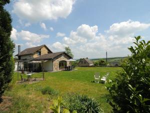 a house with a yard with chairs in front of it at Five-Bedroom Holiday Home in Somme-Leuze in Somme-Leuze