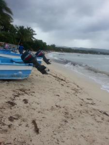 two boats sitting on a sandy beach with the ocean at B&B KeisyAlba Punta Rucia in Punta Rucia