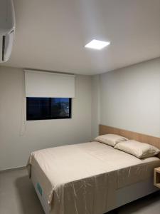 En eller flere senge i et værelse på Apto 2 Quartos Novo e Super Confortável