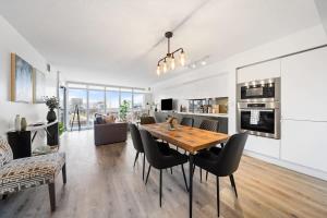 a dining room and living room with a table and chairs at Spacious Downtown Condo - Walk to CN Tower & More in Toronto