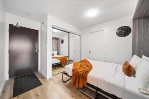 a bedroom with a large bed and a room at Spacious Downtown Condo - Walk to CN Tower & More in Toronto