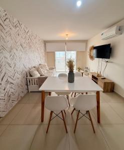 a living room with a table and two chairs at City Paz in Villa Carlos Paz