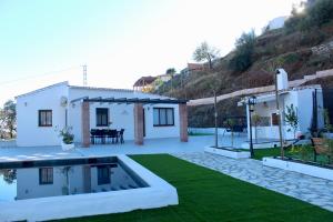 a villa with a swimming pool and a house at Casa Billota in Torrox