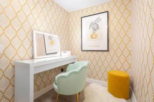 a room with a desk and a chair and a picture at Plush Yorkville Designer Condo with Glam Suite in Toronto