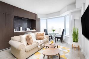a living room with a couch and a table at Plush Yorkville Designer Condo with Glam Suite in Toronto