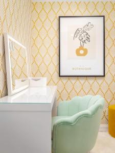 a room with a desk and a picture of a plant at Plush Yorkville Designer Condo with Glam Suite in Toronto +17 photos