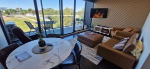 a living room with a table and a couch at Ascot Hill in Melbourne
