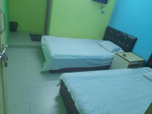 a hotel room with two beds and a blue light at Hotel New View in Chittagong